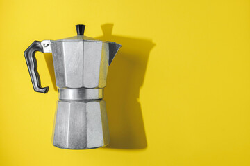 Italian Stovetop Espresso Maker (Moka Pot) on a Yellow Background