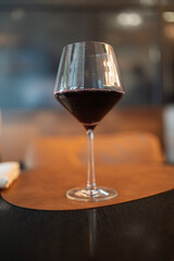 Glass of red wine resting on restaurant table