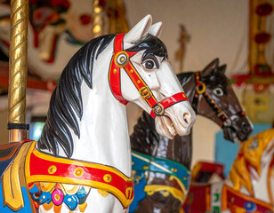 Colorful painted wooden horses, reminiscent of carousel animals, representing a whimsical aspect of Argentine folk art and childhood memories.
