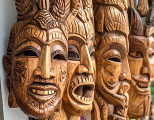 Intricate carvings on traditional Argentine wooden masks, representing folk traditions and cultural expressions of different regions.