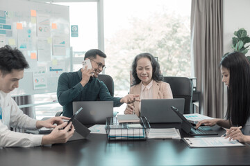 Asian business team discussing charts and graphs showing the results of successful teamwork, about investment and business growth showing the results of teamwork.