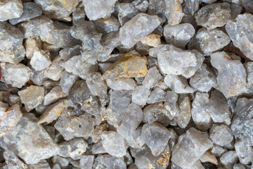 Texture and details of white decorative stone gravel close up. Pebbles for arranging garden plot ideal for decorative and construction purposes. Stones nature background. Pattern from granite material