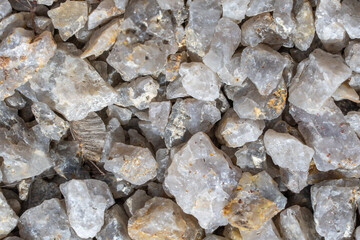 Texture and details of white decorative stone gravel close up. Pebbles for arranging garden plot ideal for decorative and construction purposes. Stones nature background. Pattern from granite material