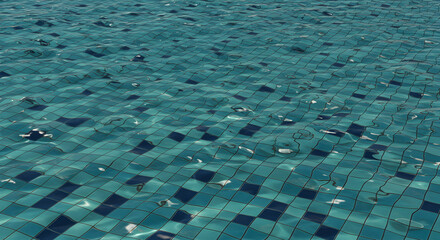 Aquatic Reflections On Turquoise Tiled Pool Water Surface With Subtle Ripples