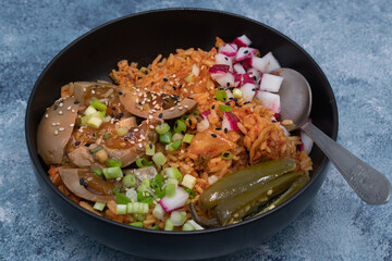 Korean kimchi rice with pickled eggs, topped with chopped fresh vegetables