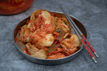 Korean kimchi in stainless steep bowl with chopsticks