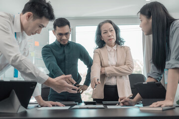 Asian business team discussing charts and graphs showing the results of successful teamwork, about investment and business growth showing the results of teamwork.