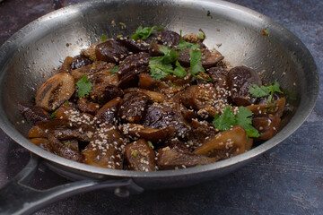 Vegan Korean eggplant gaji namul  in stainless steel pan on gray background, copy space