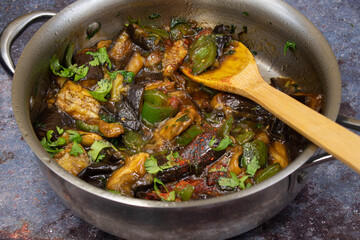 Vegan Korean eggplant gaji namul  in stainless steel pan on gray background, copy space