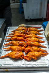 Chinese street food stall. Stuffed chicken wings on a display closeup, popular delicacy in Asia