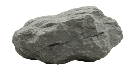 A weathered stone rests in shadow its rough texture catching the light