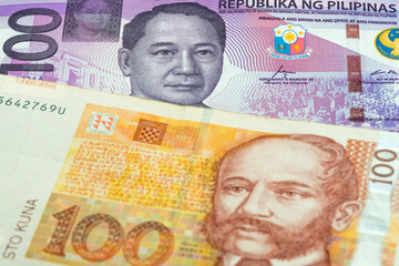 100 Philippine peso and 100 Croatian kuna banknotes. International trade concept