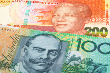 200 South Africa rand and 100 Australian dollar banknotes. International trade concept