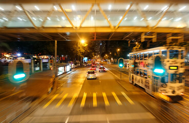 Night cityscape of Causeway Bay Downtown in Hong Kong with busy traffic of cars and a double-decker...