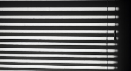 Obraz premium Obscured Light Lines Shadowing Window Blinds Creating Contrast and Abstract View