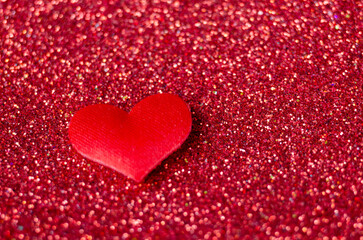 A tiny red heart on sparkle red background with customizable space for text or wishes