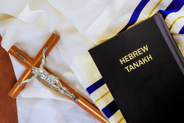24 April 2025 Jerusalem Israel Crucifix, Hebrew Tanakh are on tallit prayer shawl, reflecting...