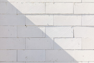 grey wall at the construction site with hollow stones
