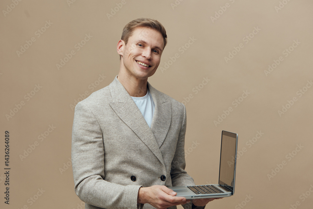 Poster smiling man working with laptop show cybersecurity concept hold open notebook beige background casua