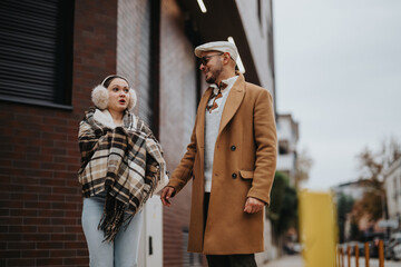 Young couple enjoying a walk outdoors in fall wearing cozy scarves