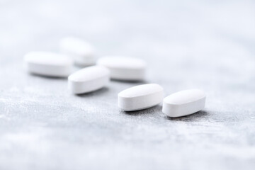 Amino acids tablets on wooden background. Soft focus. Close up	