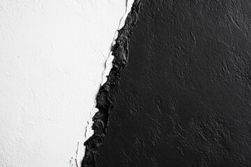 Contrasting monochrome textures.  Sharp, diagonal division between white and black surfaces.  Rough, uneven edges