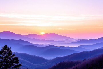 Obraz premium This breathtaking photograph captures a stunning landscape of rolling mountains painted in shades of purple and blue, set against a vivid sunset sky. The sun is setting behind the distant peaks.
