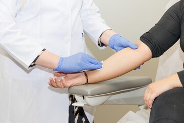 Doctor wiping patient's arm after allergy skin test during medical examination