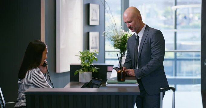 Business man, appointment and office reception at corporate consultation agency with secretary. Client, lobby and waiting room with phone at admin counter and welcome desk with check in for meeting
