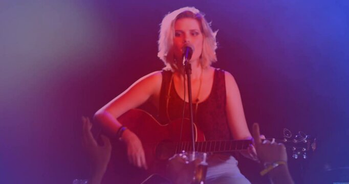 Woman singer guitarist performing on stage showing animated sound waves and charts for tech promo
