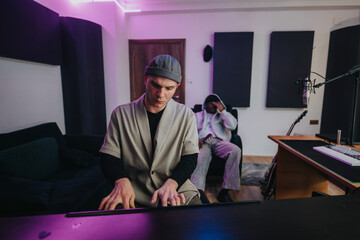 Two musicians collaborating in a studio setting, blending talents to produce creative music. The...