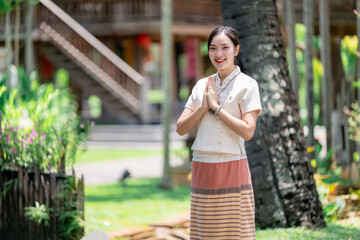 Beautiful Thai Woman Wearing Traditional Lanna Dress Greeting in Garden