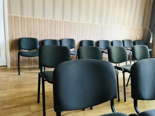 Fototapeta premium Empty chairs arranged in a room before an upcoming event