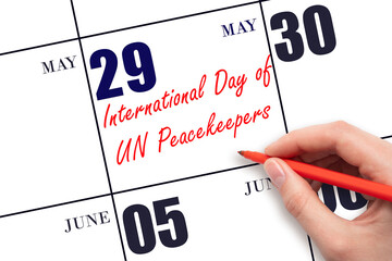May 29. Hand writing text International Day of UN Peacekeepers on calendar date. Save the date.