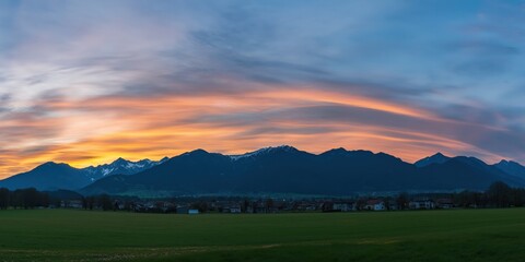 Happy woman standing with her back on sunset in nature . Panoramic view of a colorful sunset created by ai