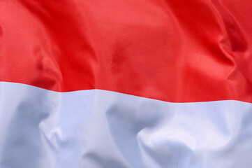 Fototapeta premium Close-up of the national flag of Indonesia fluttering in the wind, wave pattern