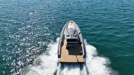 Aerial drone top down cinematic video of beautiful modern super yacht with wooden deck cruising in high speed in Aegean deep blue sea - Powered by Adobe
