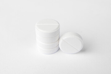 Stack of white paracetamol tablets on clean background, Close-up of several white paracetamol tablets stacked together, isolated on a plain white background, representing healthcare and medicine.