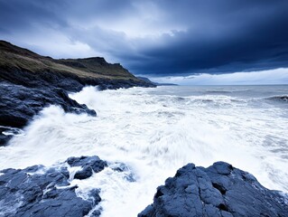 Fototapeta premium Powerful waves crash against dark rocks on a stormy coast