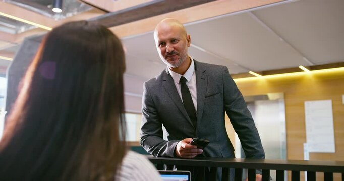 Business man, appointment and reception welcome desk at corporate consultation agency with secretary. Client, lobby and waiting room with phone at office admin counter and check in for meeting