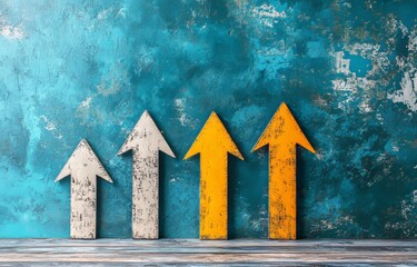 Against a dark blue wall, three arrows are arranged on a wooden floor, including one yellow arrow and two white arrows with a blue undertone