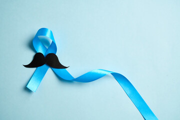 Prostate cancer awareness month and men health Blue ribbon with mustache