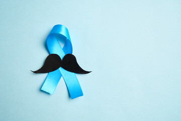 Prostate cancer awareness month and men health Blue ribbon with mustache