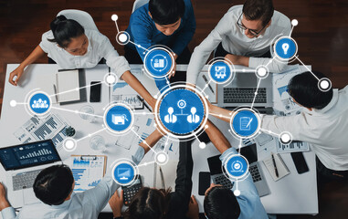 Aerial view of a diverse team working together in a modern office, utilizing technology for...
