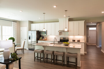Interior Design of a beautiful modern kitchen with center island. Real estate concept.
