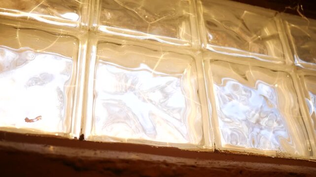Brilliant sunlight coming through basement glass block windows