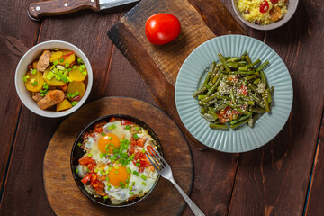 Set table, Jewish food, tzimmes, chelnt, shakshuka and couscous