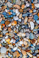 Colorful natural pebbles close-up texture with various shapes and sizes