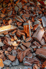 Pile of broken red bricks and debris from demolished building