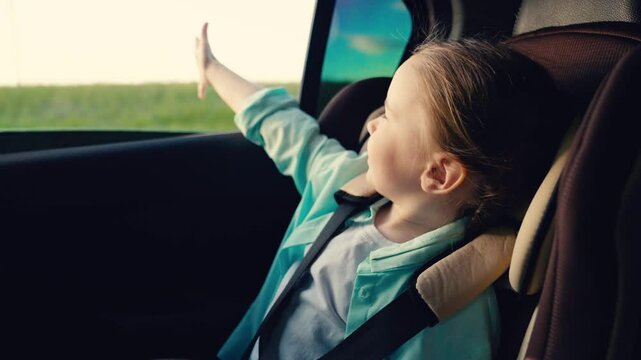 Child experiencing a road trip, young traveler enjoying the scenery, blissful moment of discovery, family vacation on the road, child&rsquo;s joy in a moving car, peaceful countryside journey, escape into